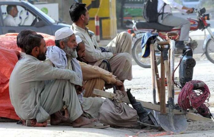 RAWALPINDI: Labourers sitting on a roadside waiting for clients to be hired for daily work.