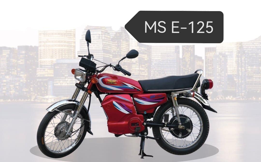 A red motorcycle parked in front of a sign Description automatically generated with medium confidence