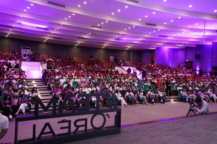 A large auditorium with a crowd of people AI-generated content may be incorrect.